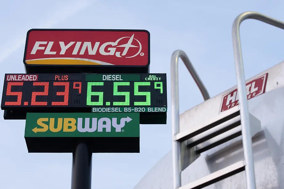 Gasoline prices near a vehicle transporting fuel at a gas station in Oregon.
