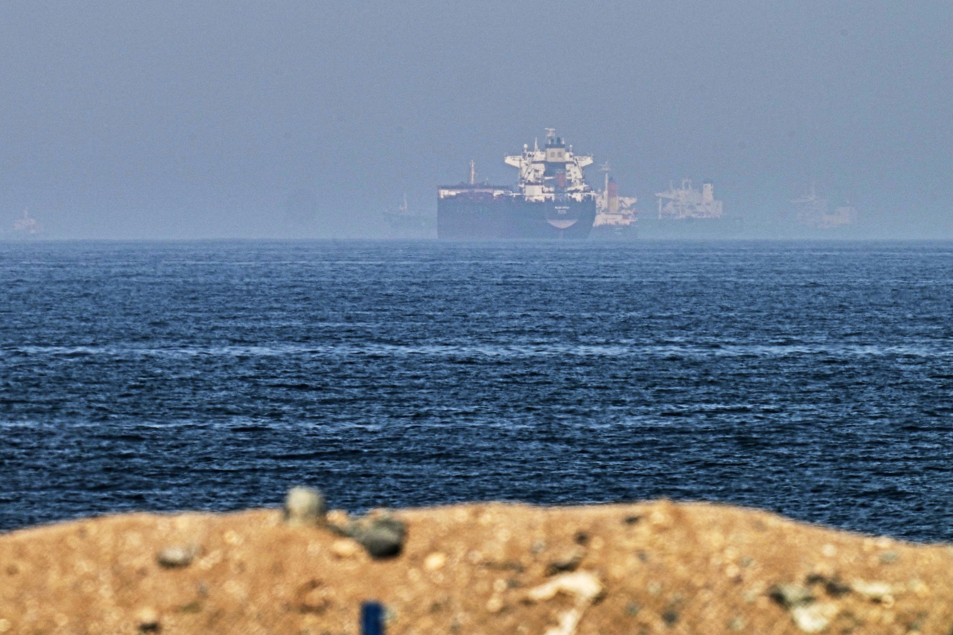An Emirati patrol boat sails near a tanker anchored in the Gulf of Oman, near the Strait of Hormuz.