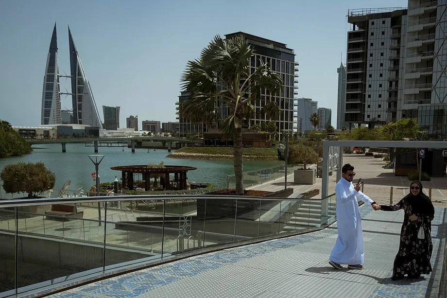 A man takes a photo of his partner in Bahrain.