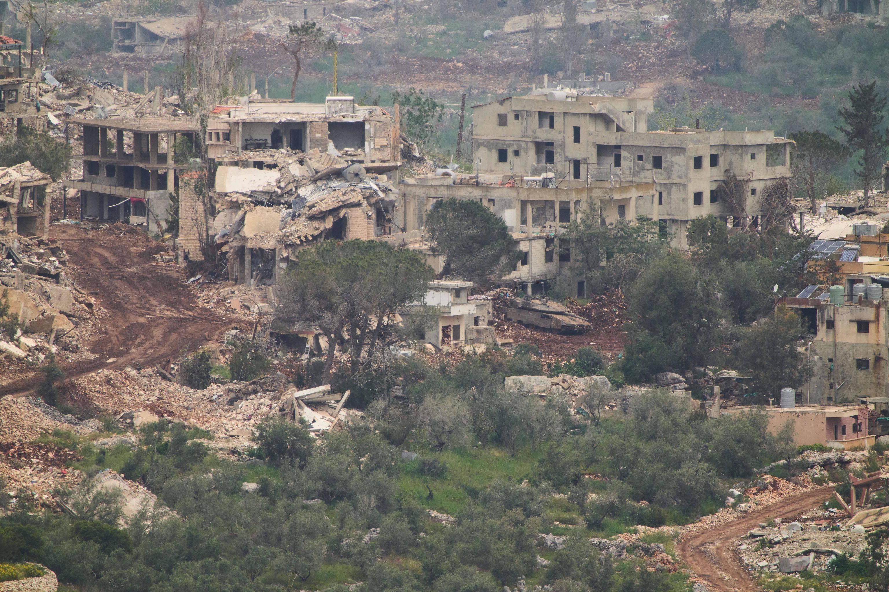 Israeli soldiers drive a tank inside a village in southern Lebanon.
