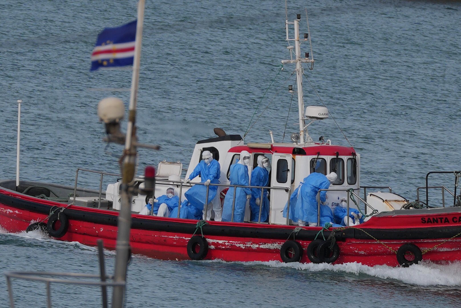 Health workers with protective equipment participate in the evacuation of hantavirus patients to Praia, the capital of Cape Verde.