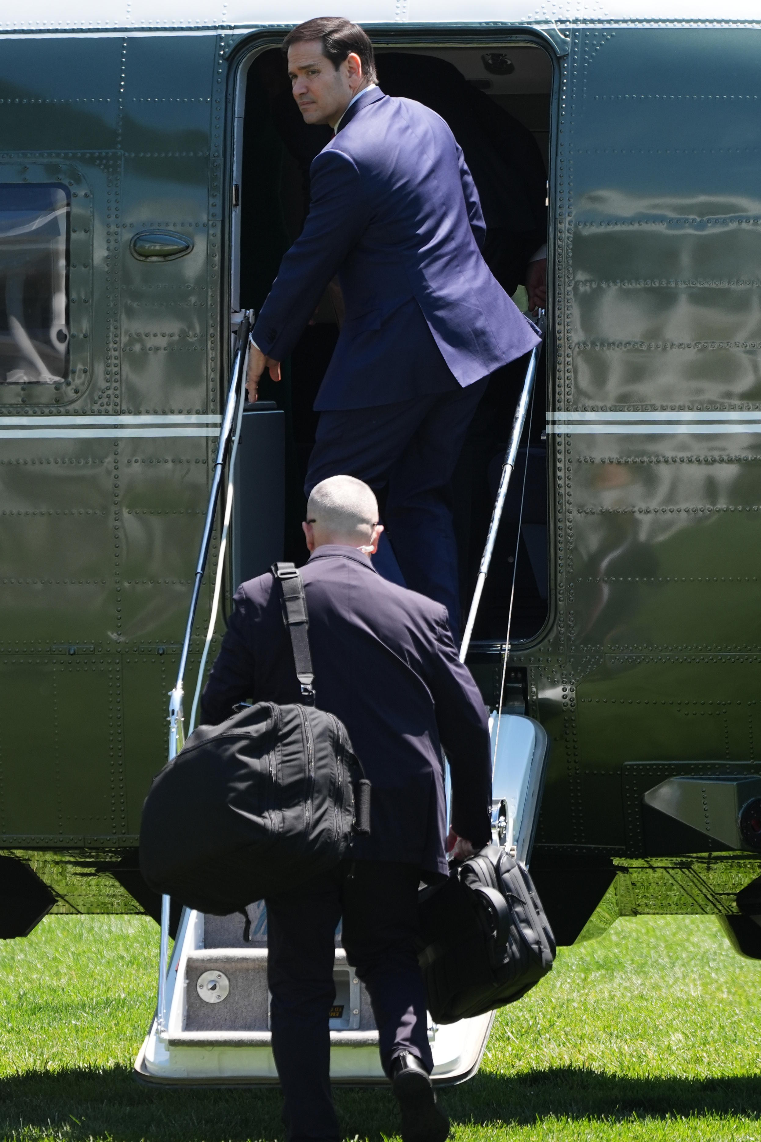 Marco Rubio boards Marine One on the South lLawn of the White House for travel to Beijing.