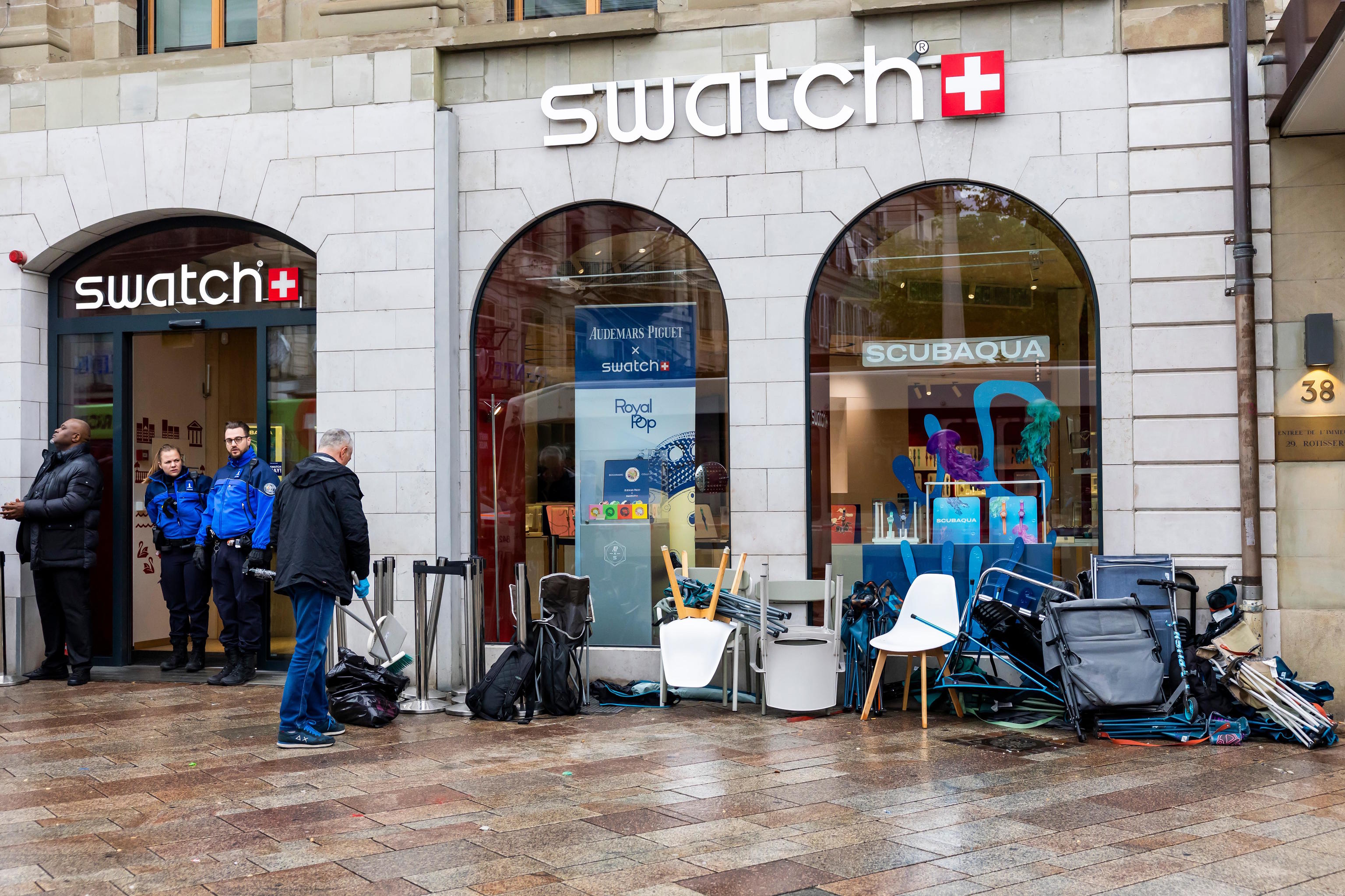 Swiss police officers secure the area to buy the new Royal Pop watch by Swatch.