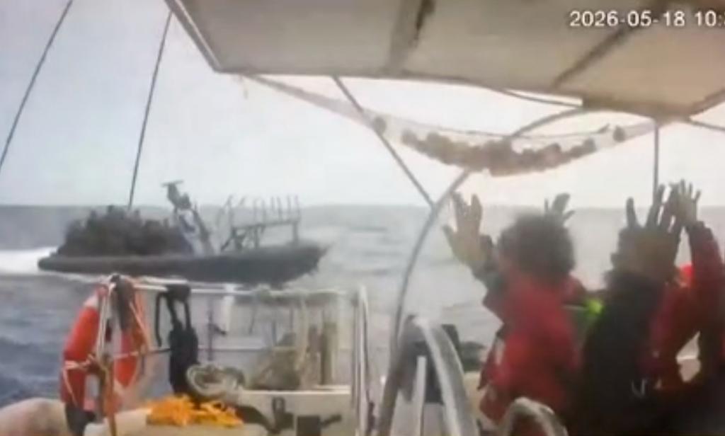 This grab from CCTV footage shows activists aboard a flotilla boat with their hands in the air