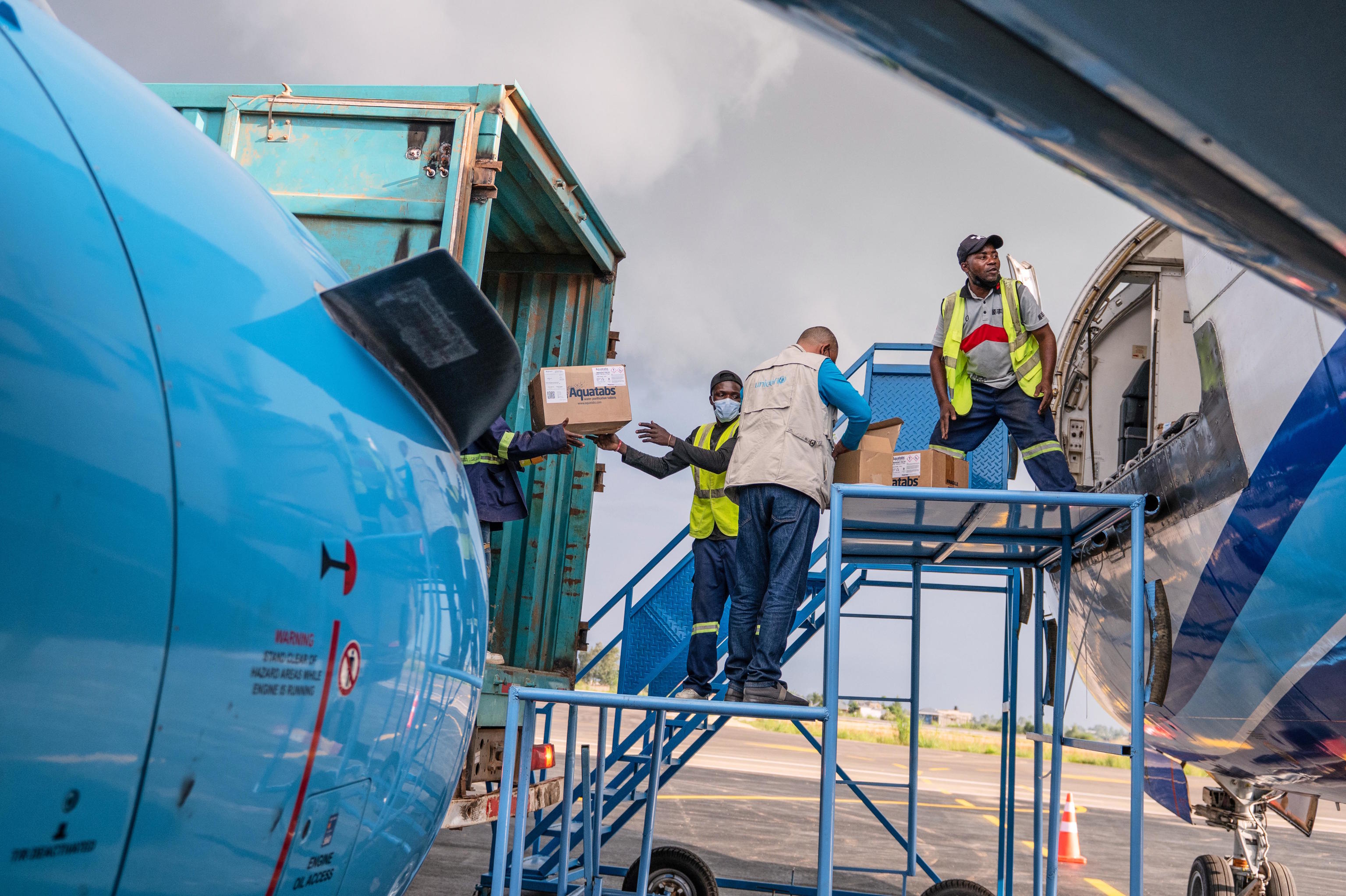 People offload a shipment of more than 15 tons of supplies at Bunia National Airport in Bunia, Congo.