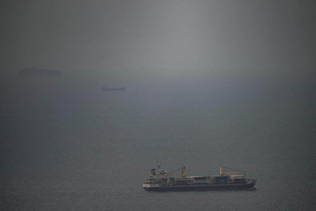 A cargo ship sails in the Persian Gulf toward the Strait of Hormuz