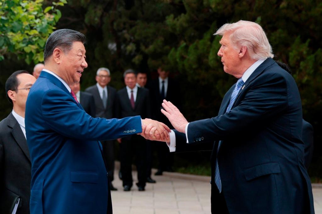 U.S. President Donald Trump, right, shakes hands with Chinese President Xi Jinping