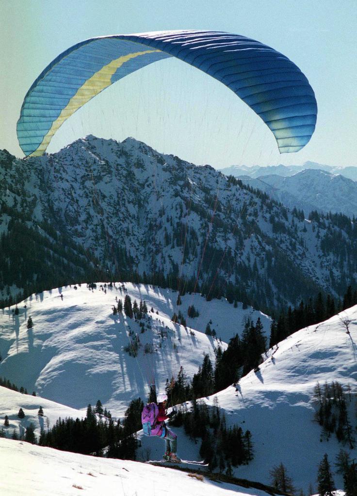 Paragliding and skiing in the Bavarian Alps.