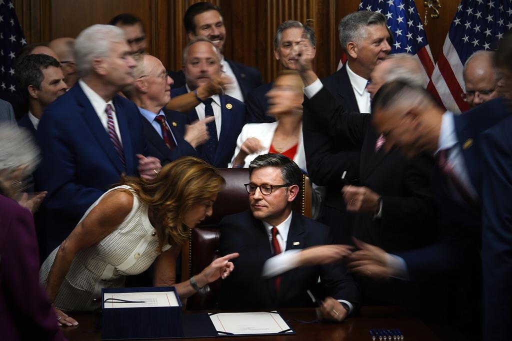 Republican Congresspeople reach to shake hands with Speaker of the House Mike Johnson