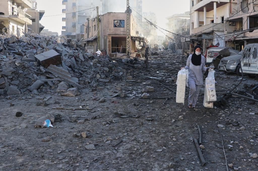 A woman salvages items from her shop.