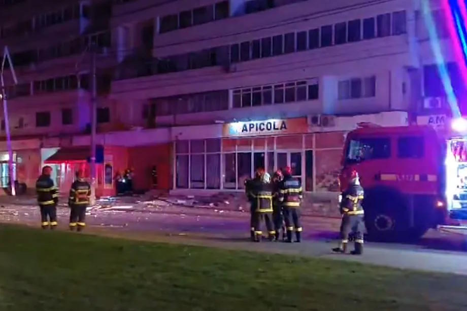Romania's emergency services at the building affected by the drone impact.