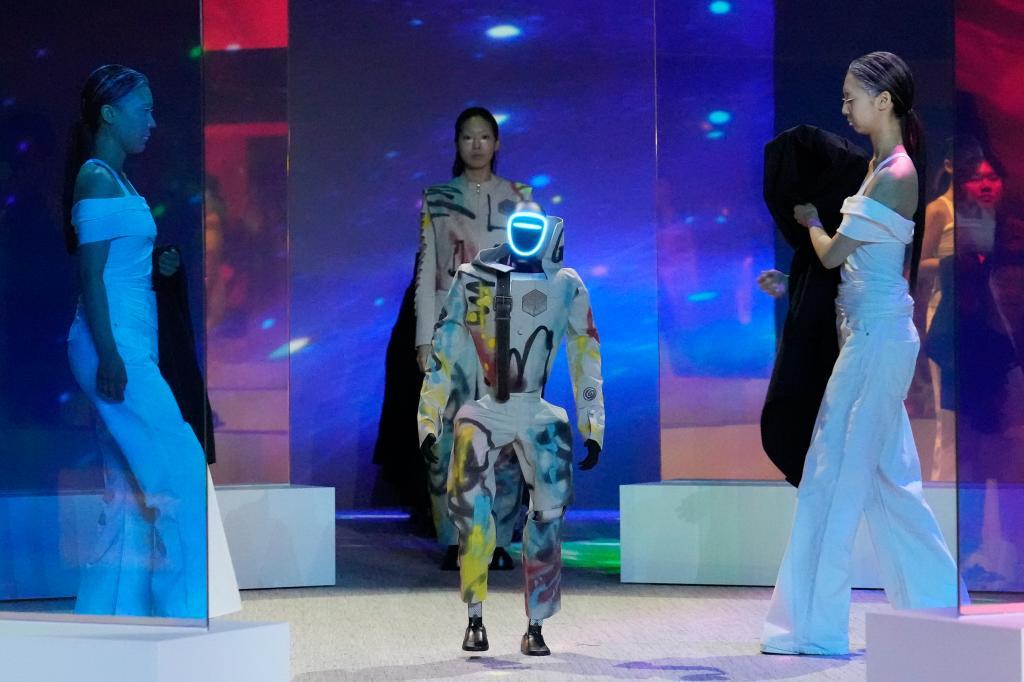 A humanoid robot and model take part in the Galaxy Corporation's MACH33