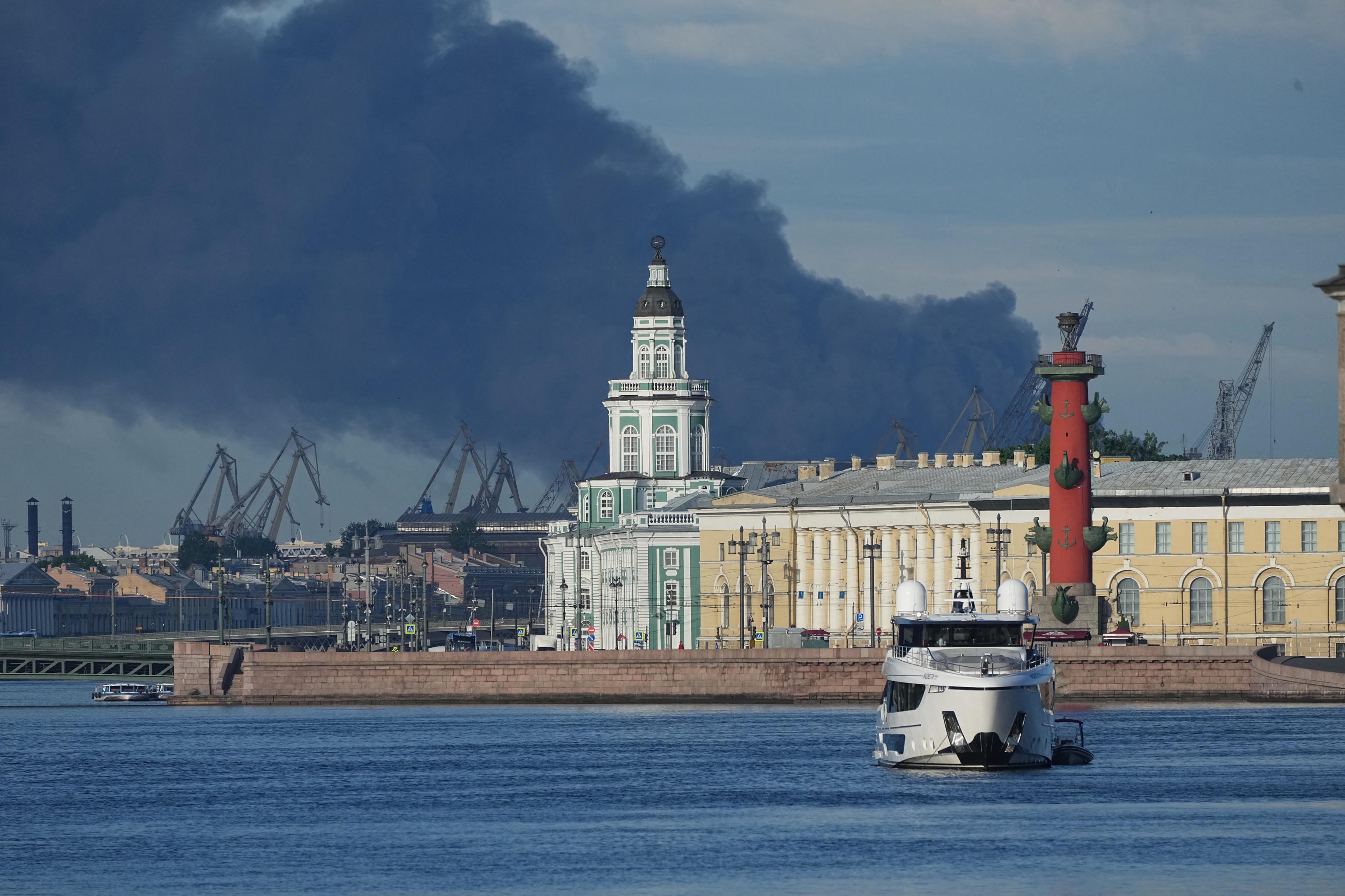 A plumes of black smoke is seen over the port of St. Petersburg.