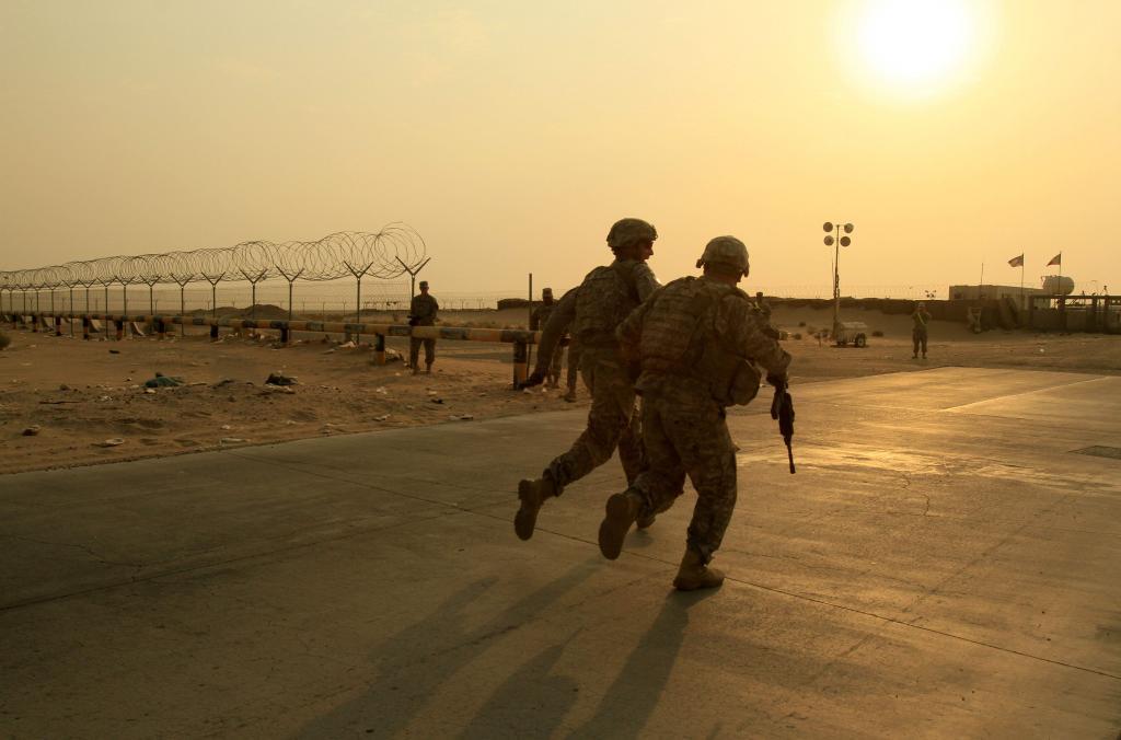 Two soldiers from the 2nd Battalion of the 23rd Infantry Regiment are heading to the border between Iraq and Kuwait