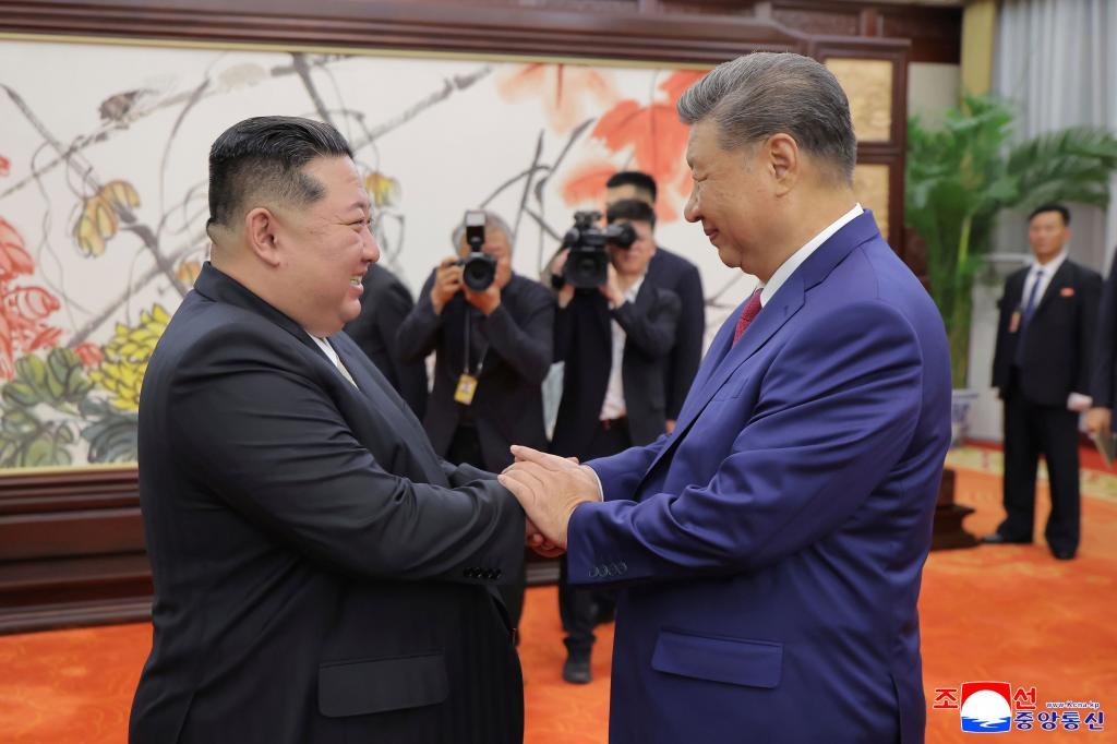 North Korean government, North Korean leader Kim Jong Un, left, shakes hands with Chinese President Xi Jinping in Beijing