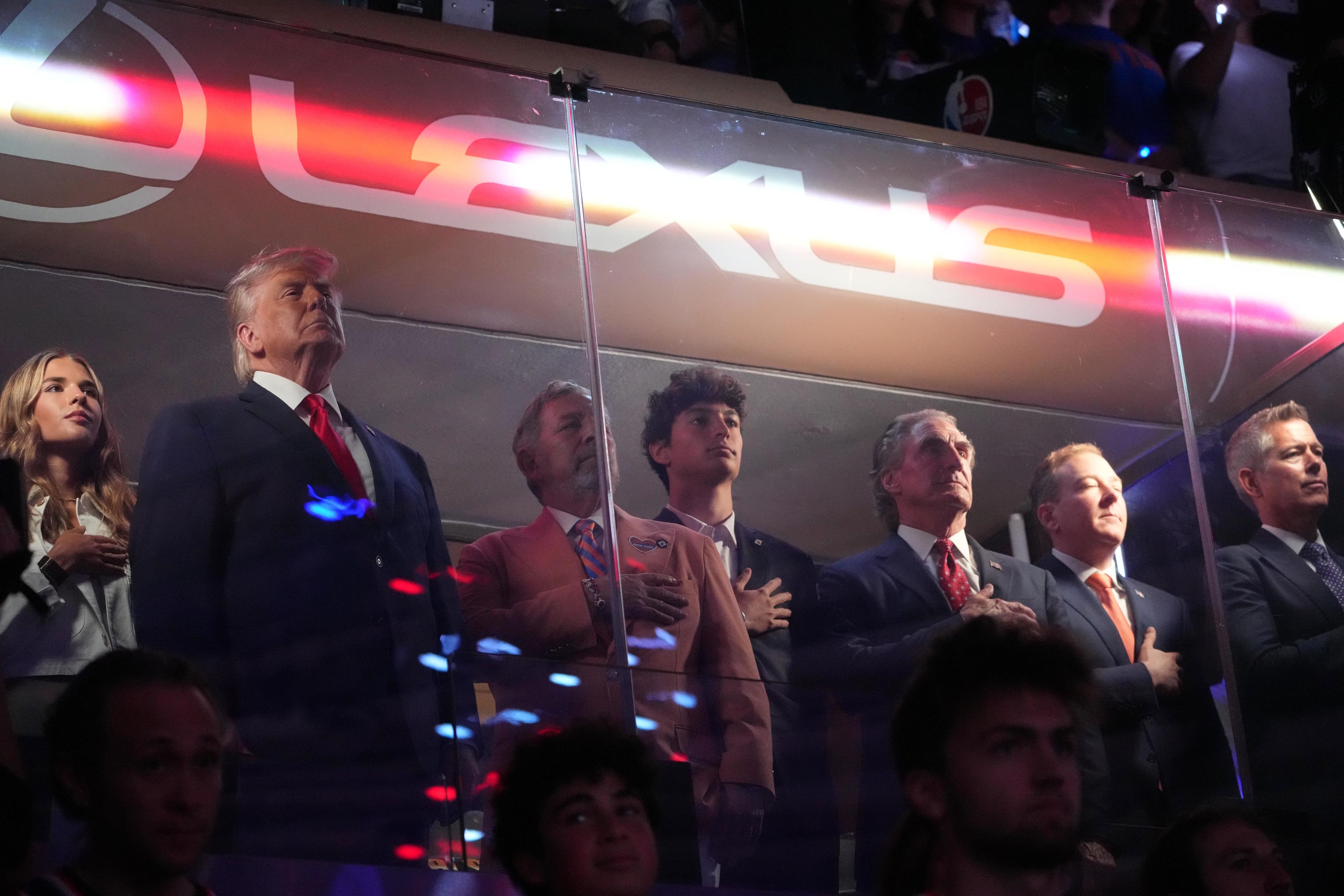 President Donald Trump gestures during the National Anthem.