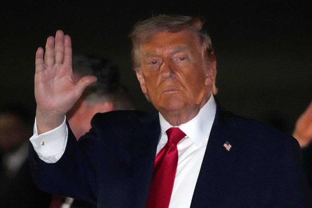 U.S. President Donald Trump gestures as he steps off Air Force One