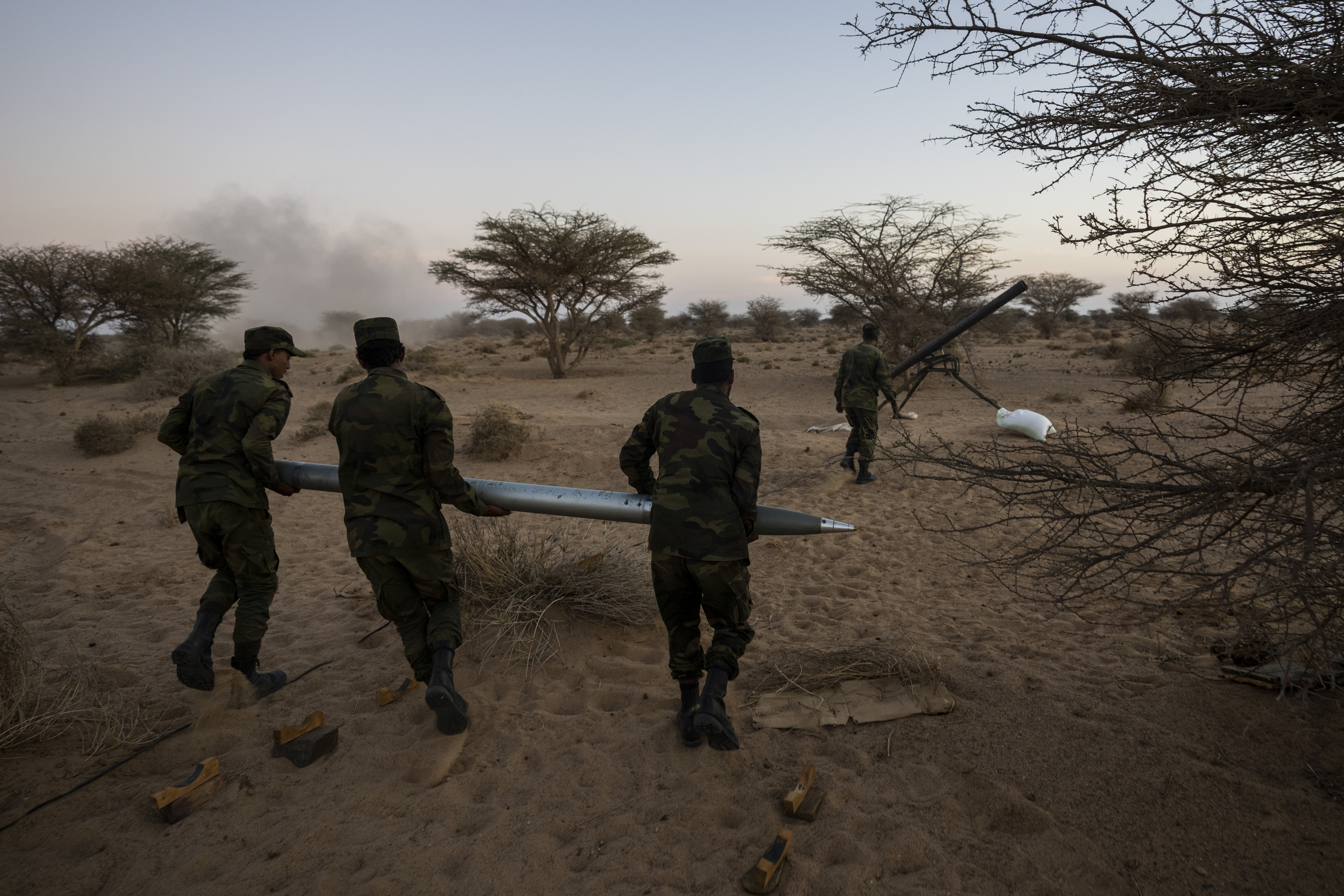 Polisario Front soldiers carry a rocket during an attack against Morocco, near Mehaires, Western Sahara, Thursday, Oct. 14, 2021.
