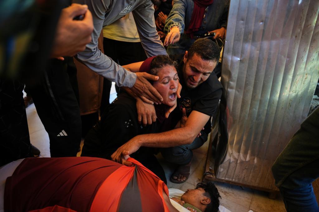Abeer Abu Younis mourns over the body of her son