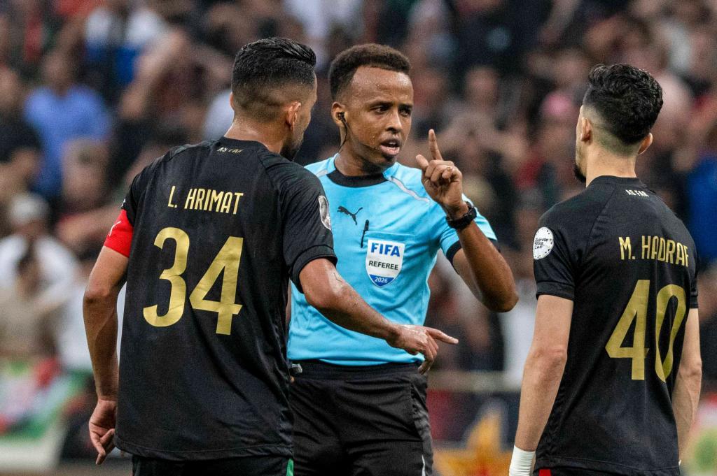 Referee Omar Artan, center, of Somalia.