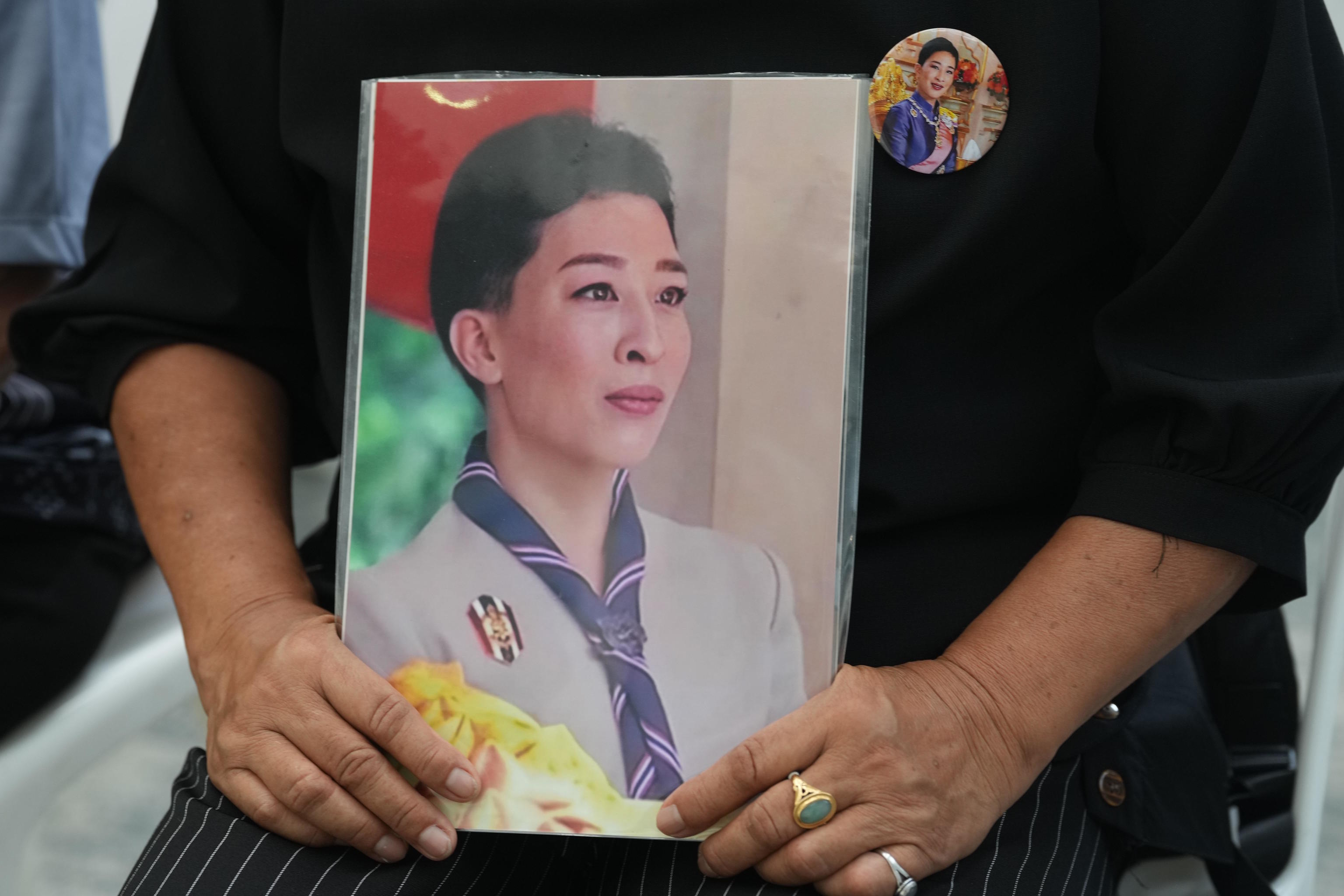 A woman holds a picture of Thailand's Princess Bajrakitiyabha Mahidolin.