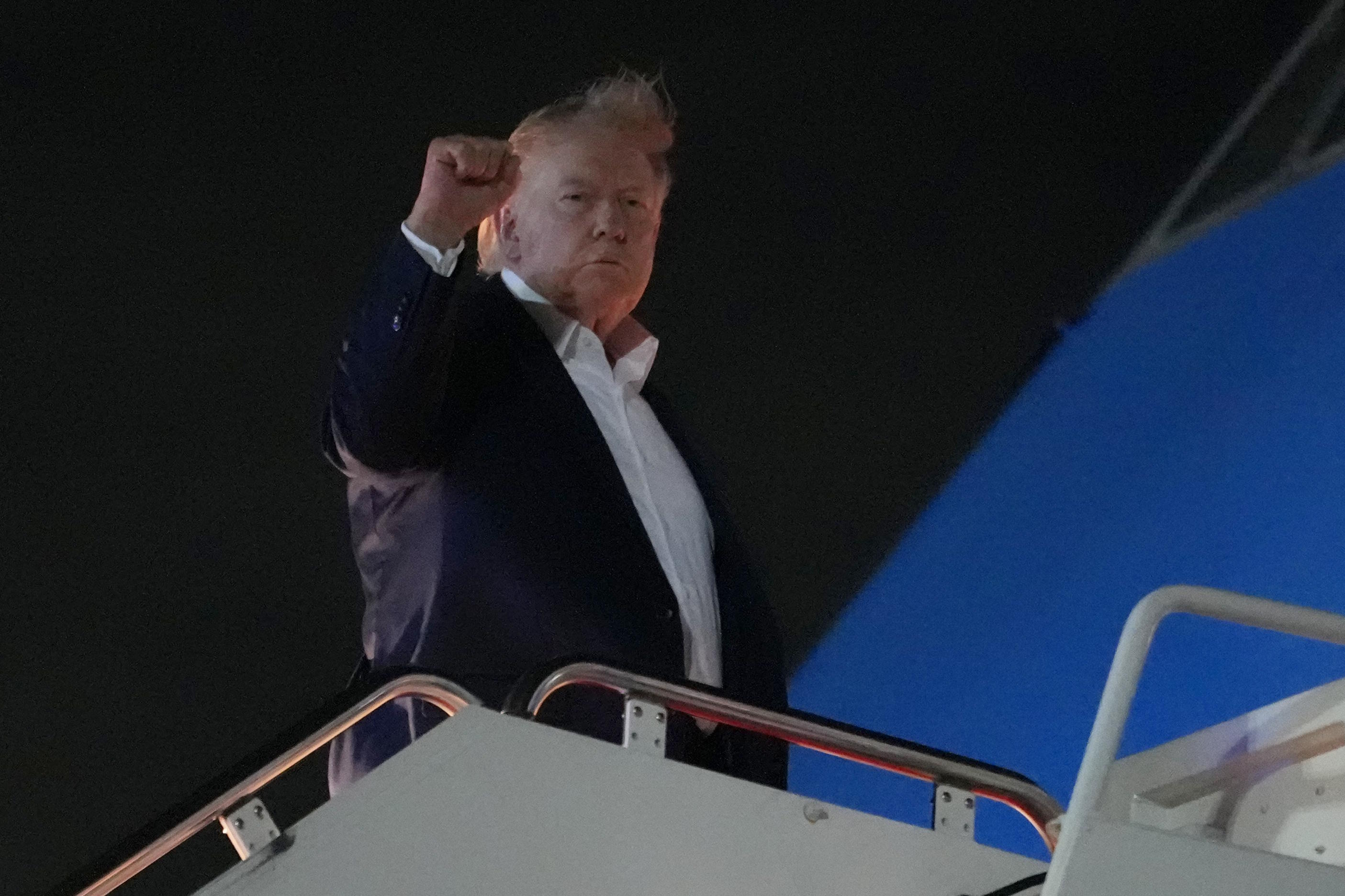 President Donald Trump gestures as he boards Air Force One.