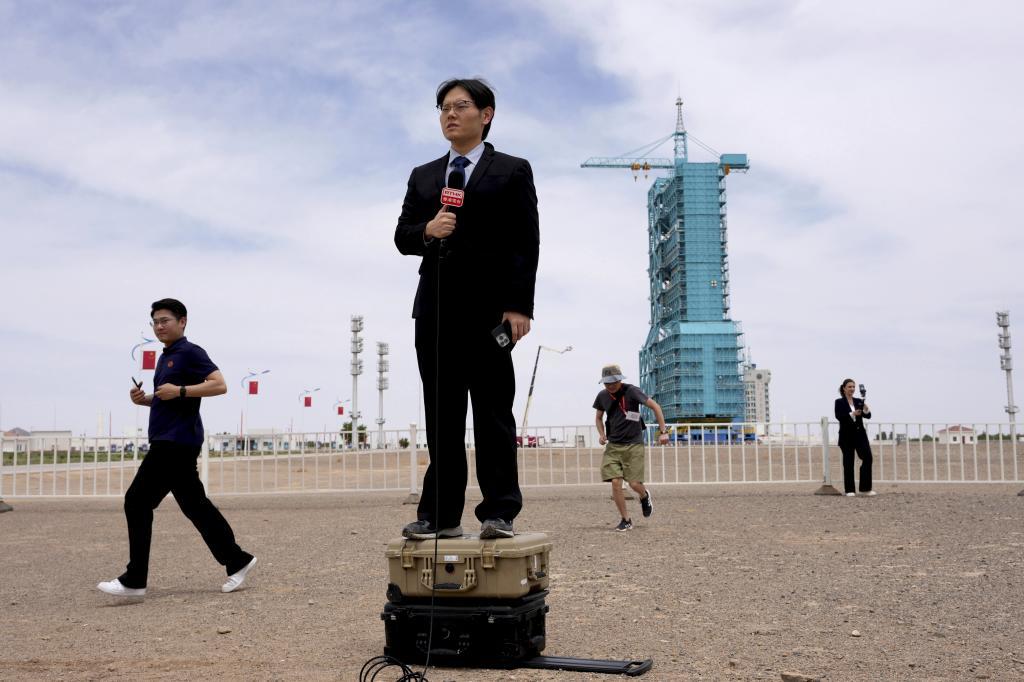 Journalists work near the launch pad for the Shenzhou-23 manned mission