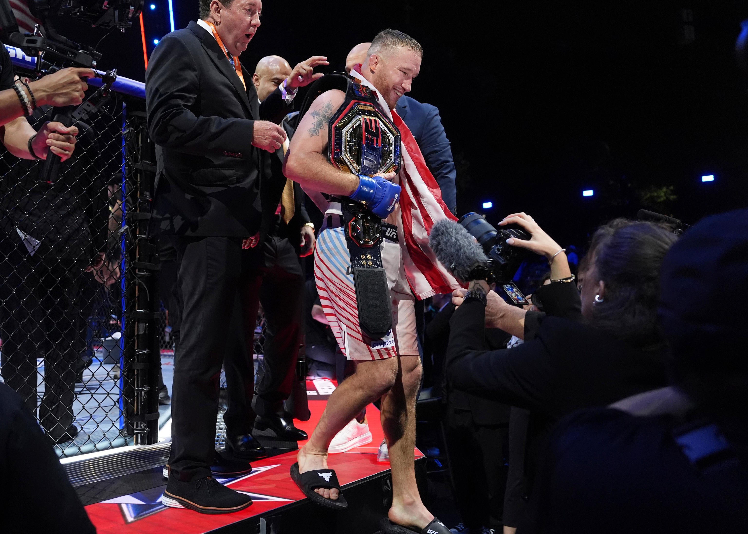 Justin Gaethje exits the ring after defeating Ilia Topuria.