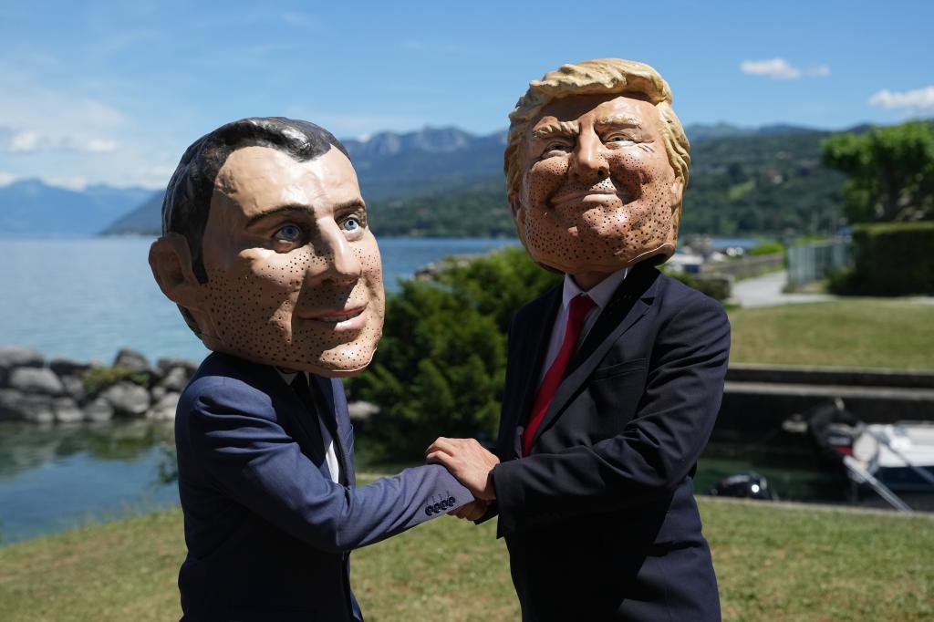 Oxfam's satirical 'big heads' of the G7 leaders depicting French President Emmanuel Macron, left, and U.S. President Donald Trump