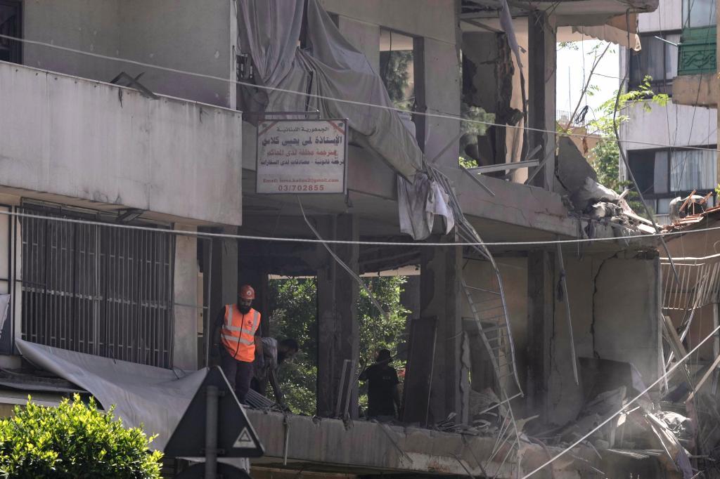 A rescue worker checks an apartment that was hit in an Israeli airstrike in Dahiyeh