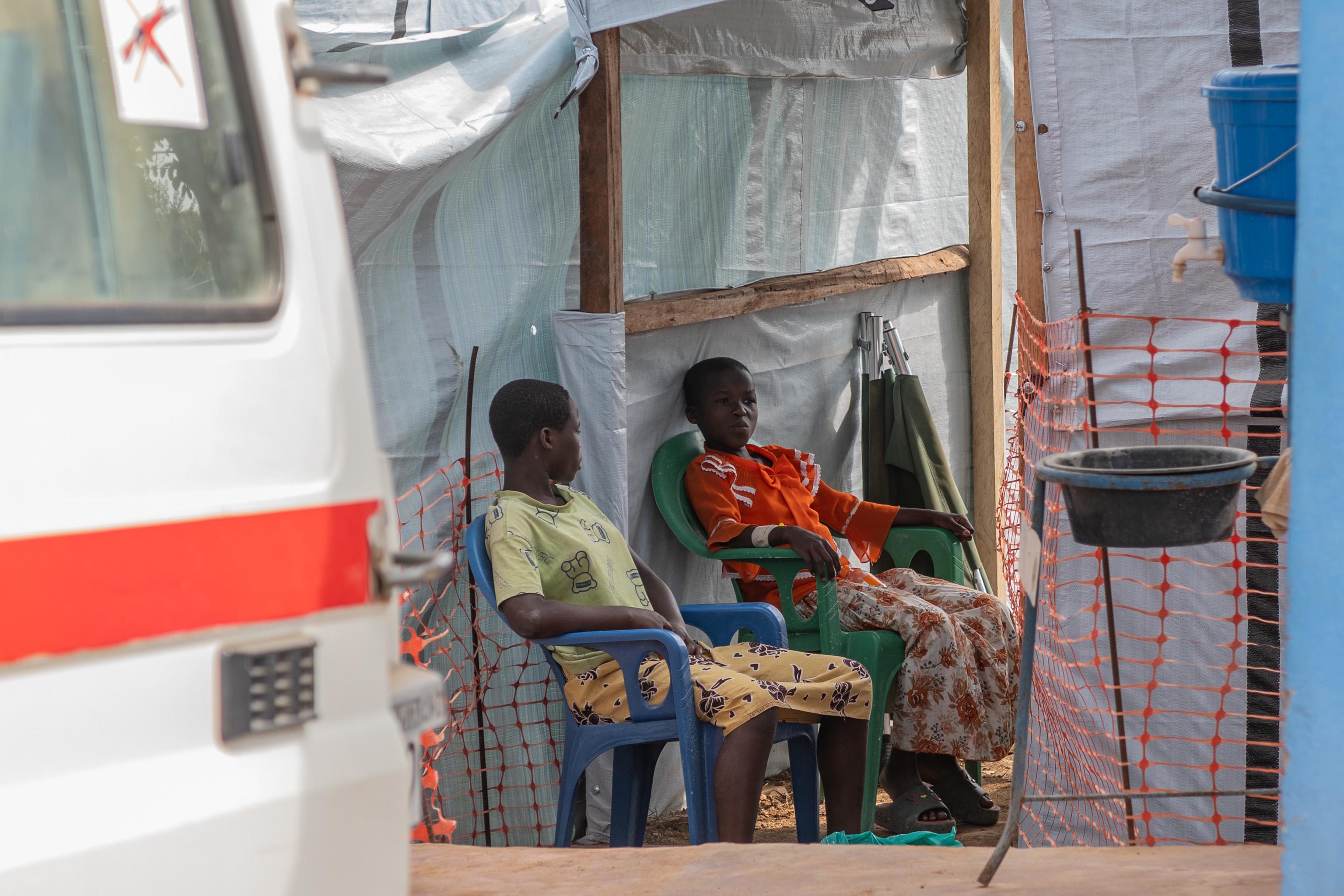Two girls sit at the isolation center in Bunia, Congo.