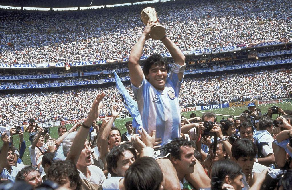 Diego Maradona of Argentina celebrates with the cup at the end of the World Cup soccer final in the Atzeca Stadium