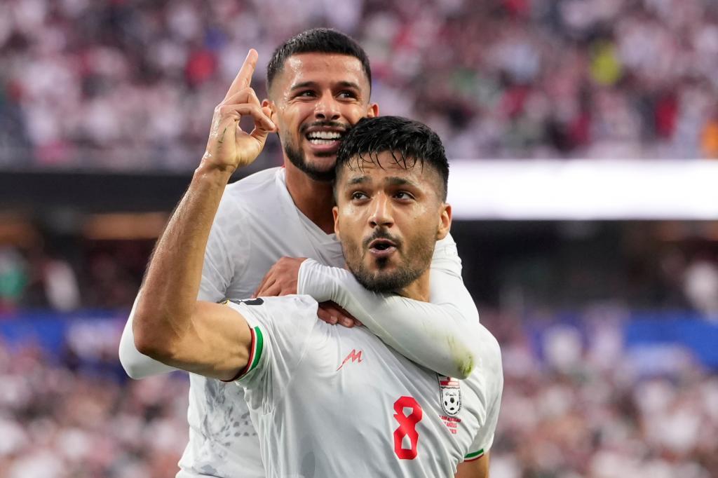 Iran's Mohammad Mohebbi (8) celebrates after scoring