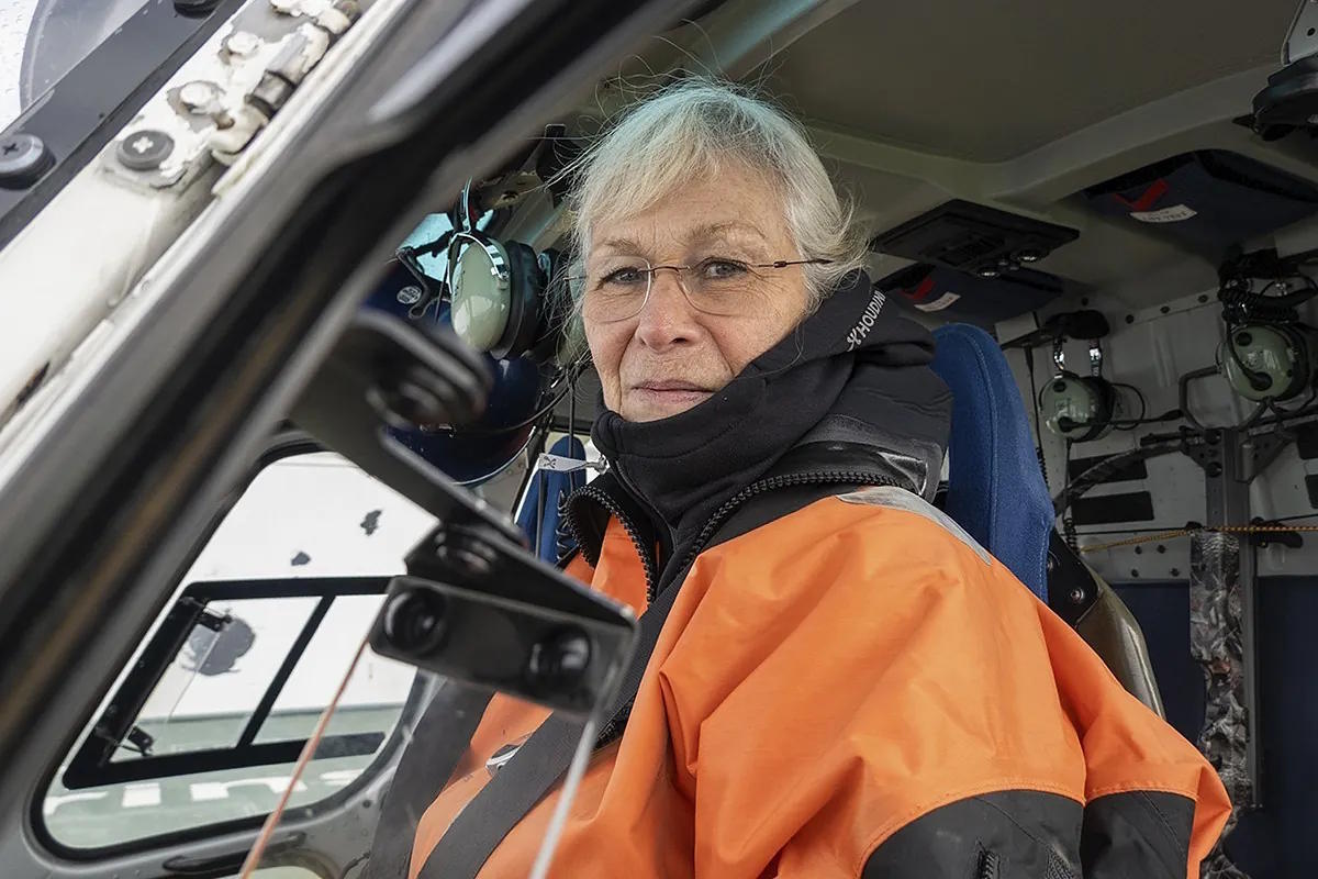 Biologist Kit Kovacs, head of the program in Svalbard, in a helicopter.