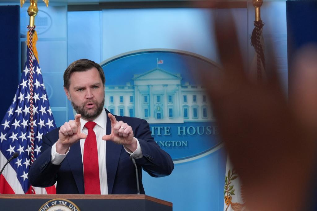 A reporter raises a hand to ask a question as Vice President JD Vance
