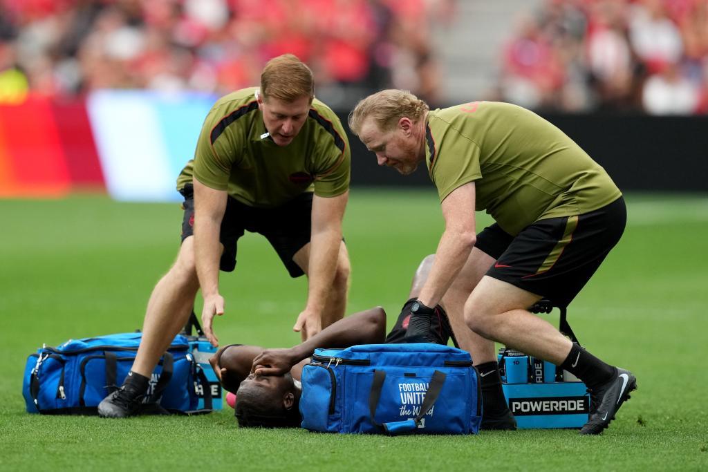 Medical staff attend to Canada's Ismael Kone.
