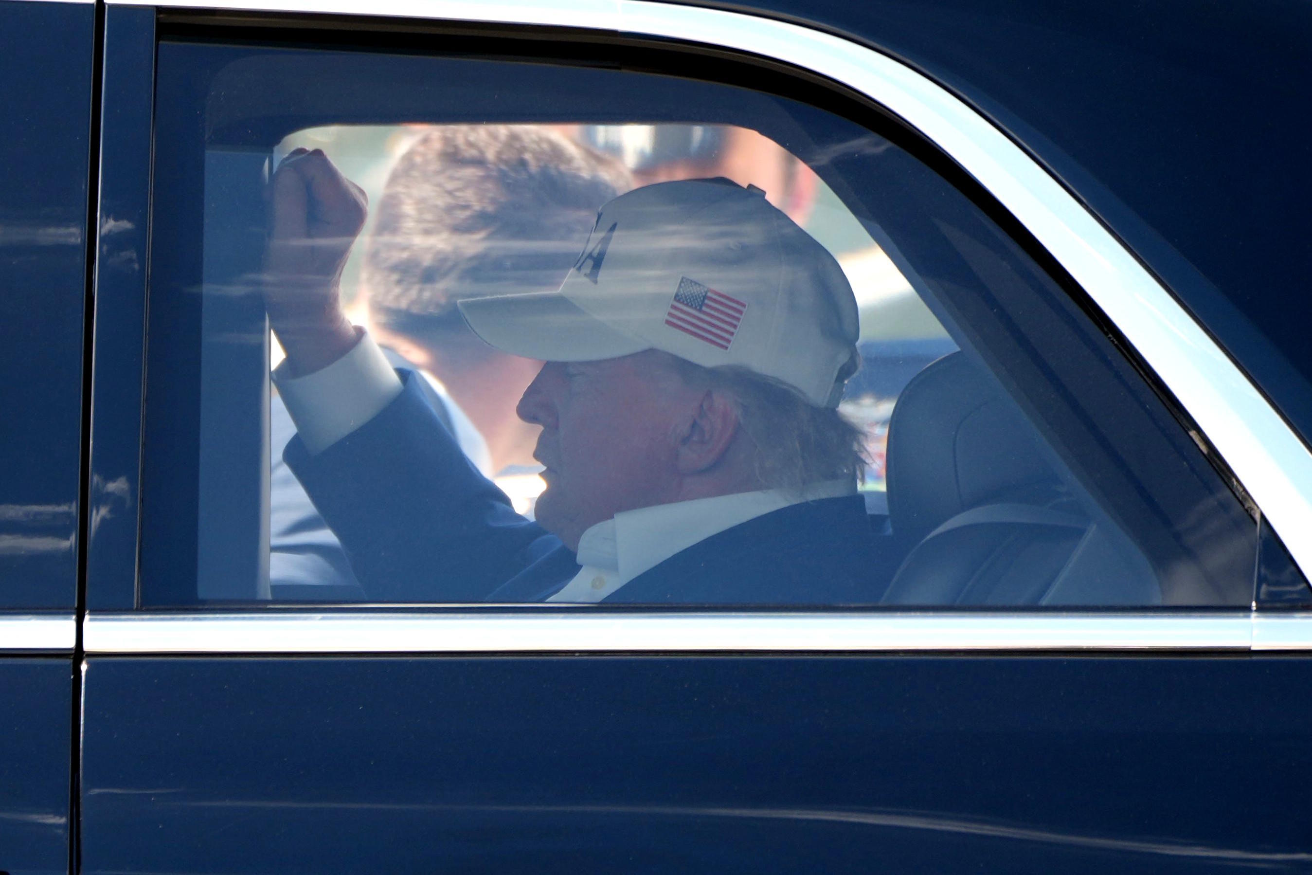 President Donald Trump sits in his limousine.