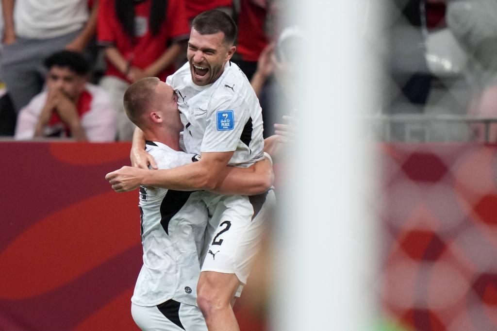 New Zealand's Finn Surman (16) celebrates his goal with teammate Tim Payne (2)
