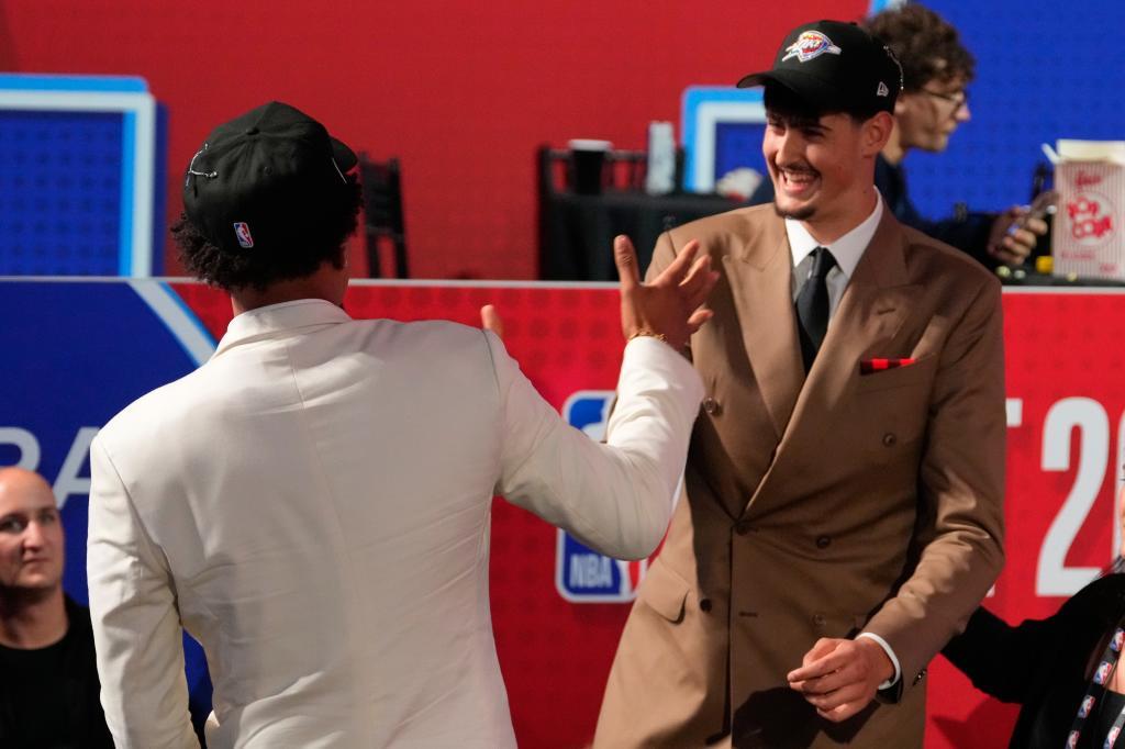 Aday Mara, right, celebrates with Yaxel Lendeborg, left, after being selected by the Oklahoma City Thunder