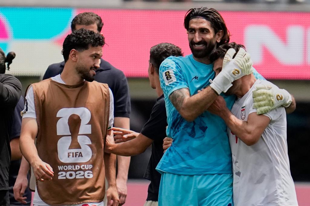 Iran players react at the end of the World Cup Group G soccer match between Belgium and Iran