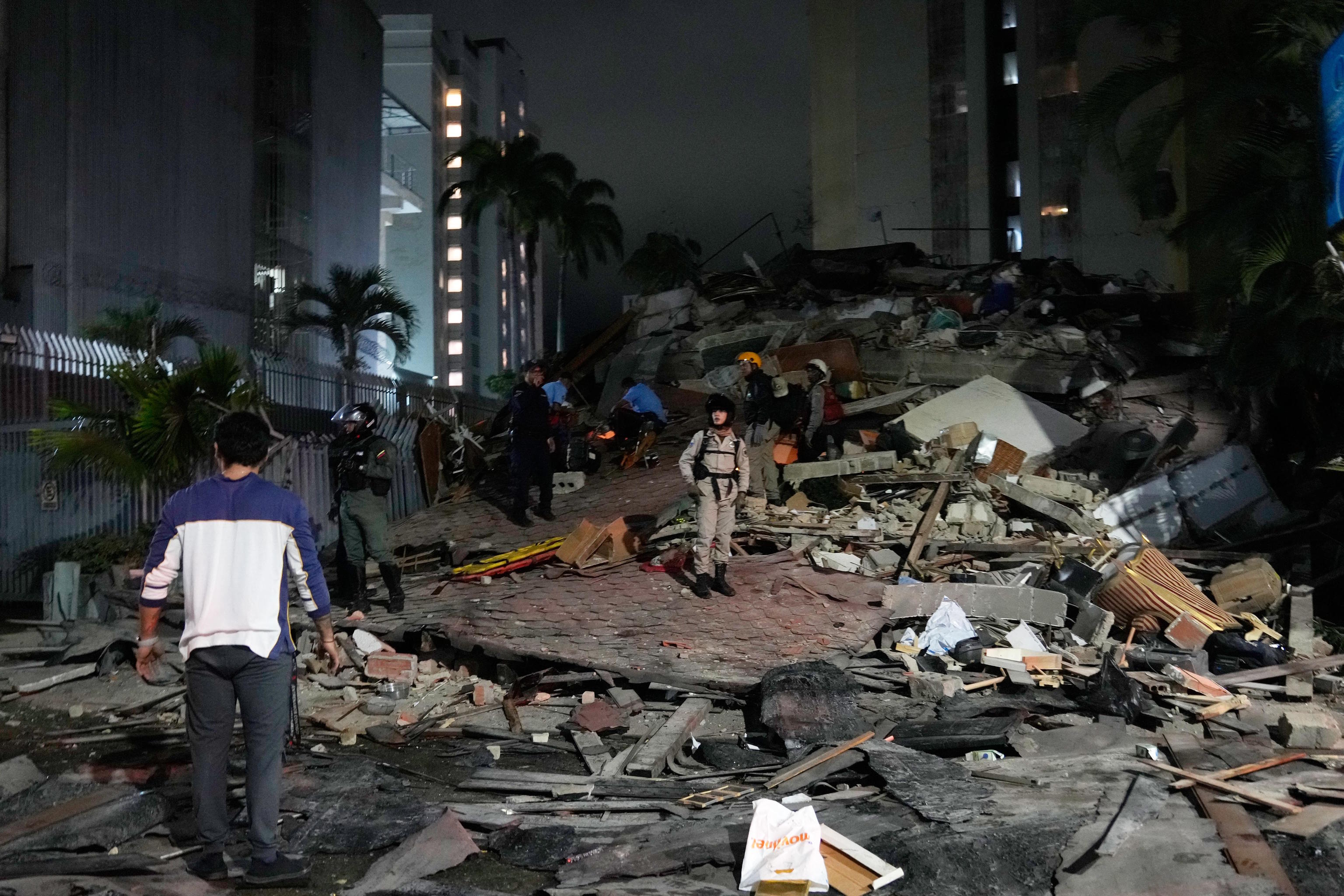 People walk among the rubble in Caracas.