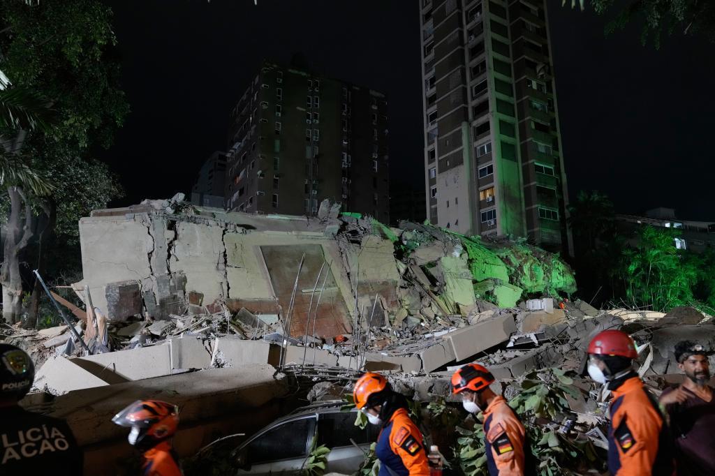 Rescue workers search through the rubble of a collapsed building after an earthquake in Caracas, Venezuela.