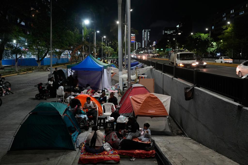 People camp in the street the night after the earthquake struck Caracas