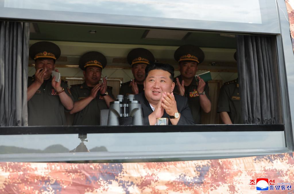 Leader Kim Jong Un, center, observes the weapon tests