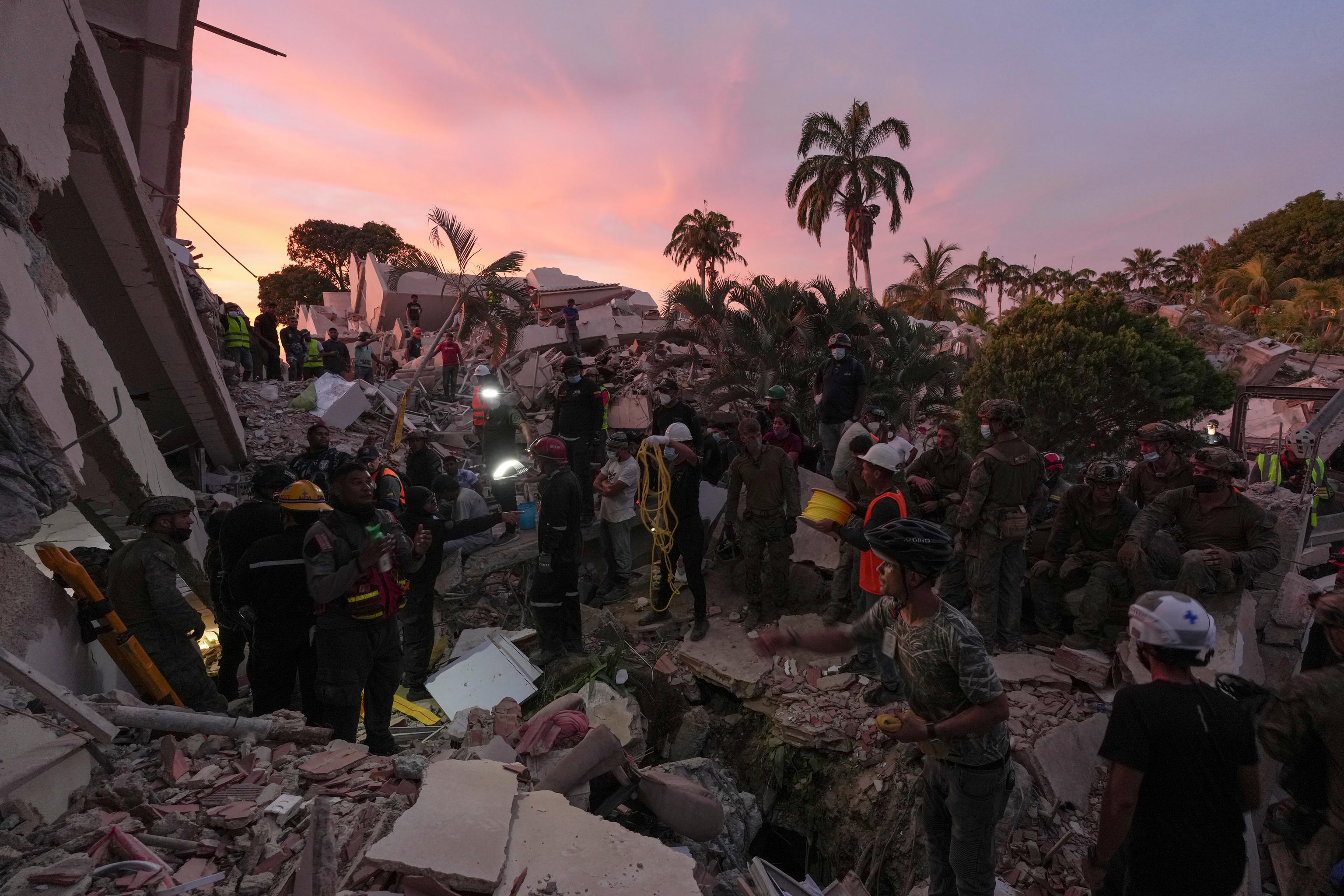 Rescuers search a building where for earthquake survivors in La Guaira.