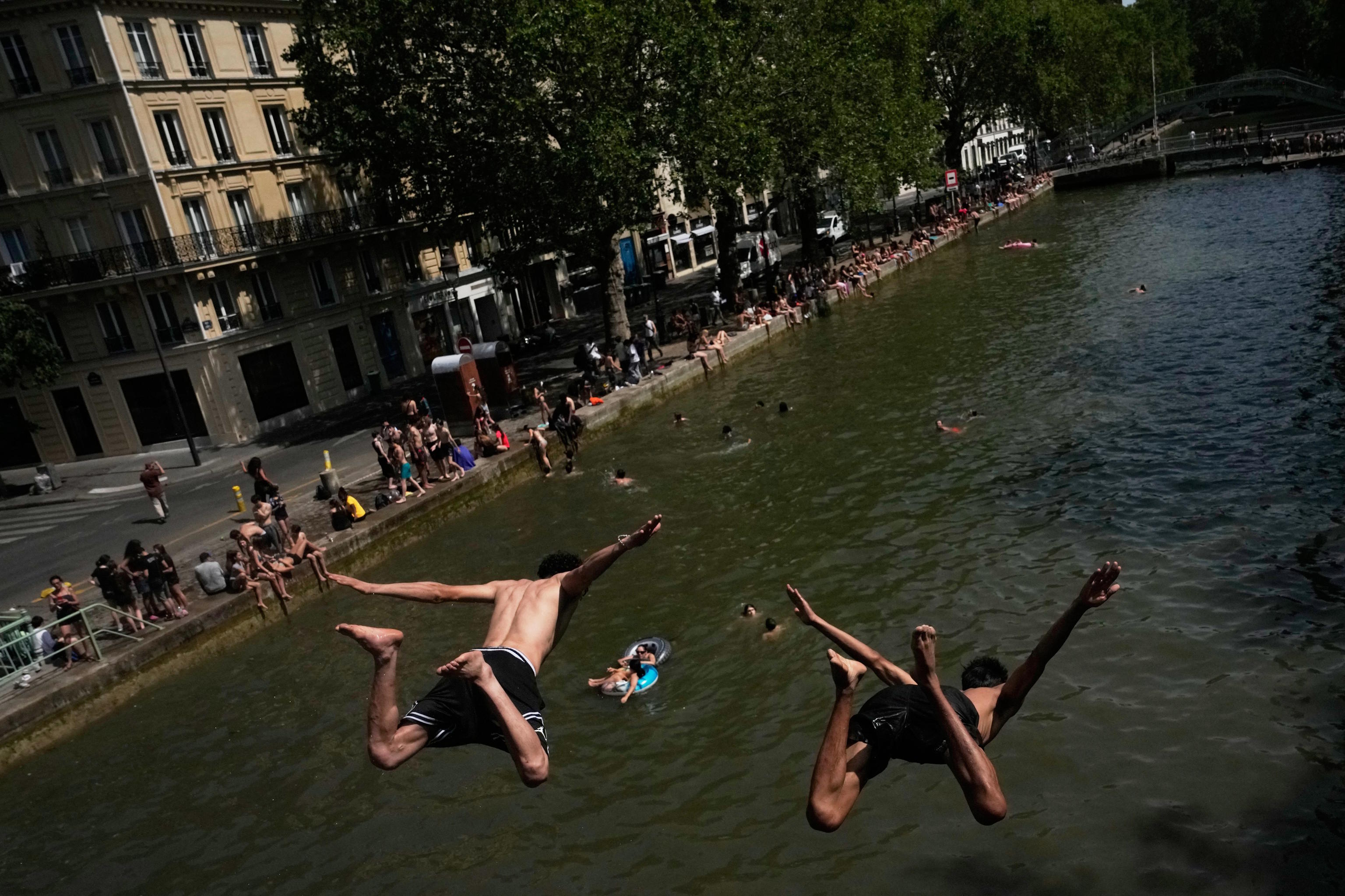Parisians bath in the Canal Saint-Martin in Paris.