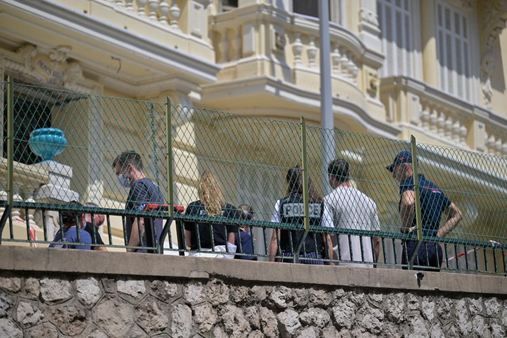 Investigators examine the scene at the residential building where an explosive device seriously injured three people a day earlier in Monaco