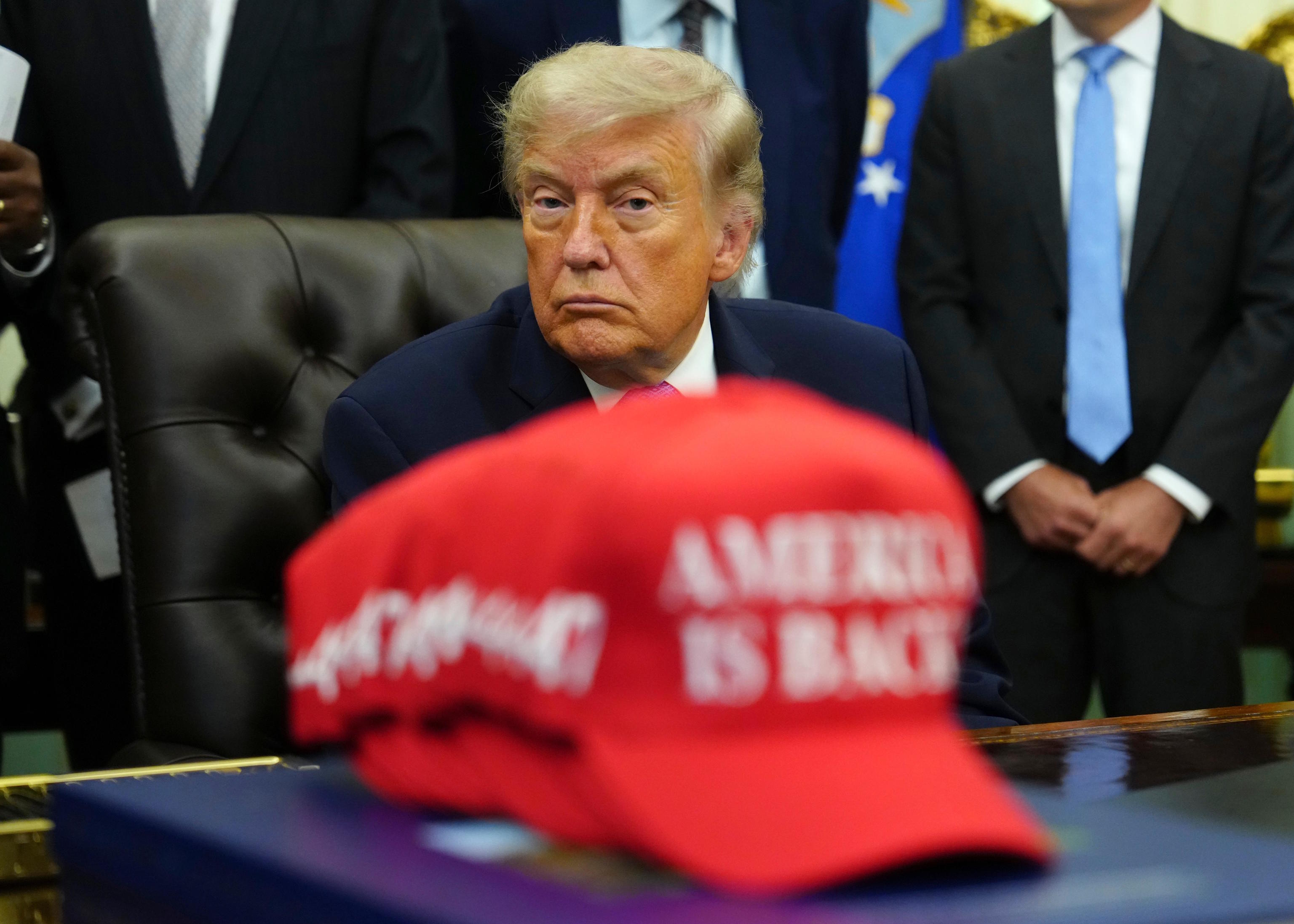 President Donald Trump sits in the Oval Office of the White House.