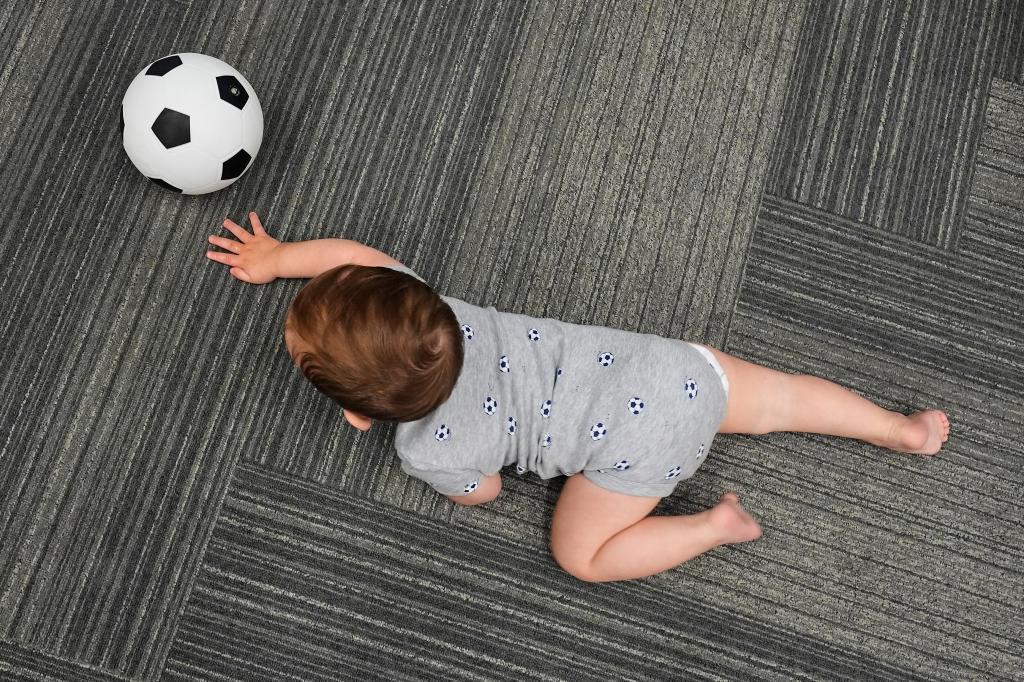 Ten-month-old Beck Ehinger plays with a soccer ball