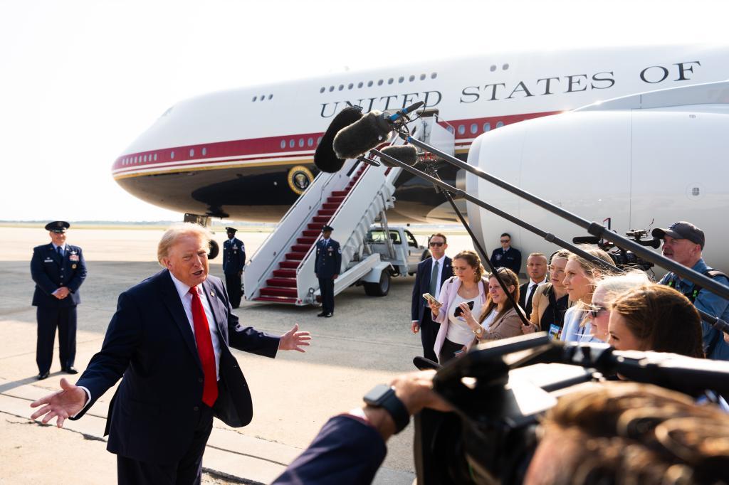 President Donald Trump speaks with reporters before boarding the new Air Force One